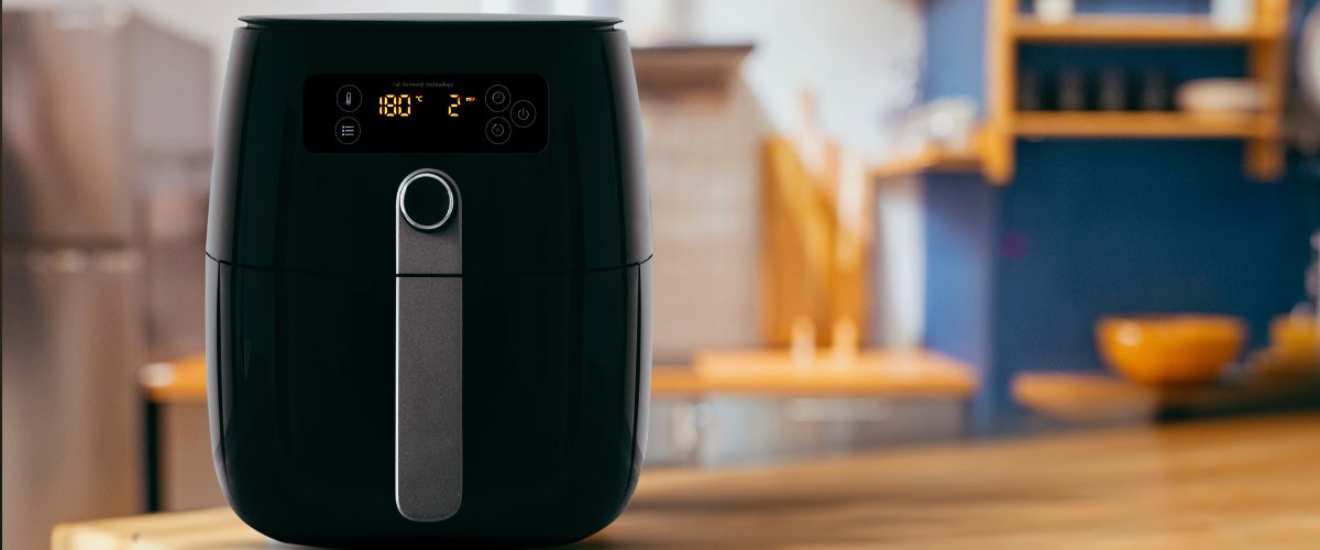 Air fryer on wooden kitchen counter
