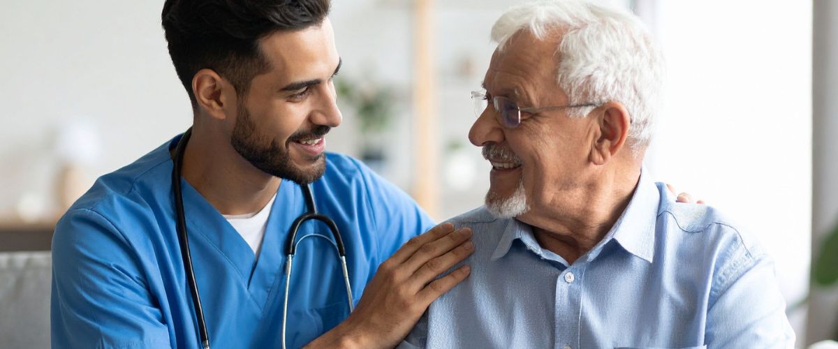 Caregiver supporting senior man