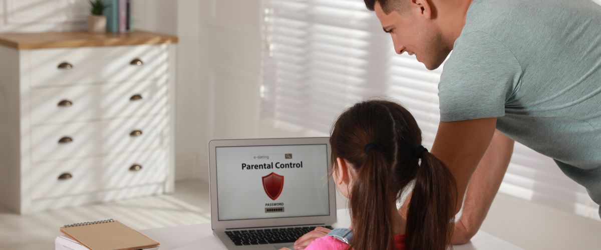 Father installing parental control app on laptop