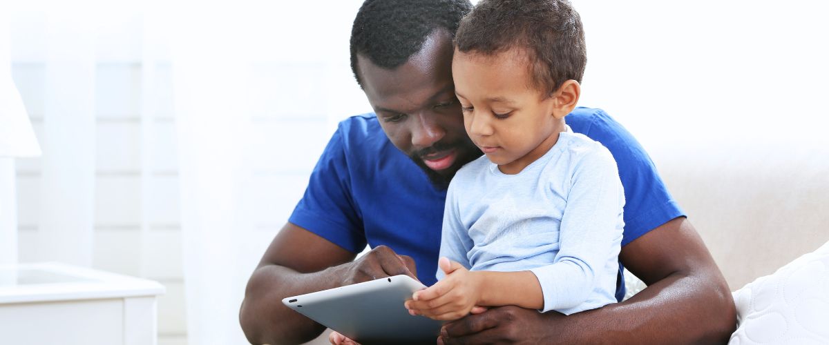 Father and son on tablet