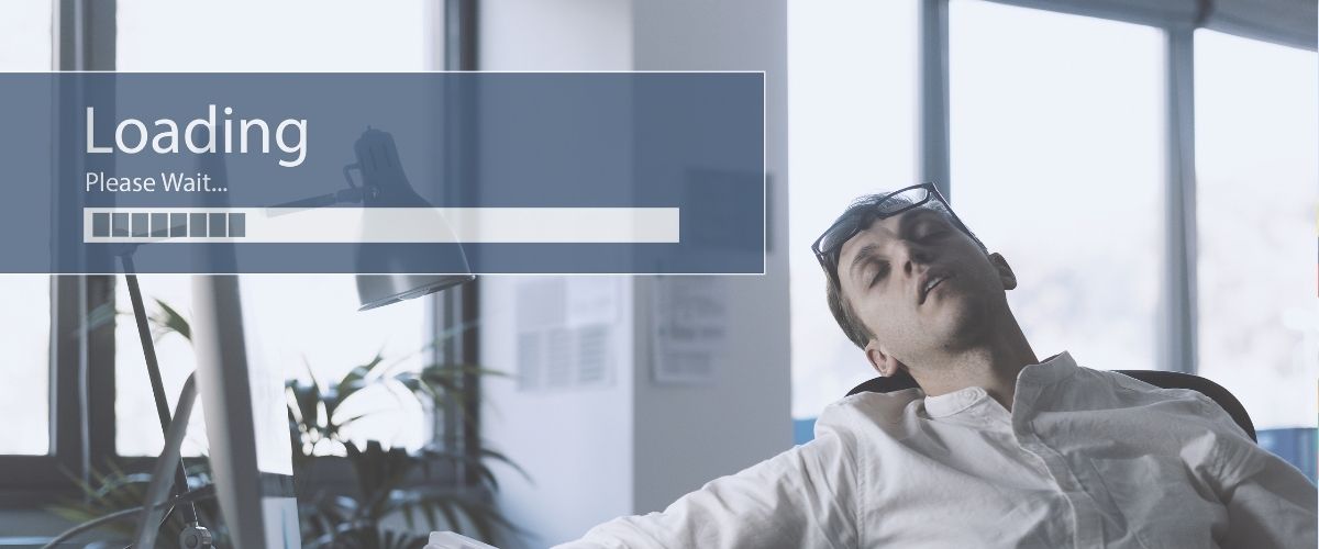 Person asleep waiting for computer to load