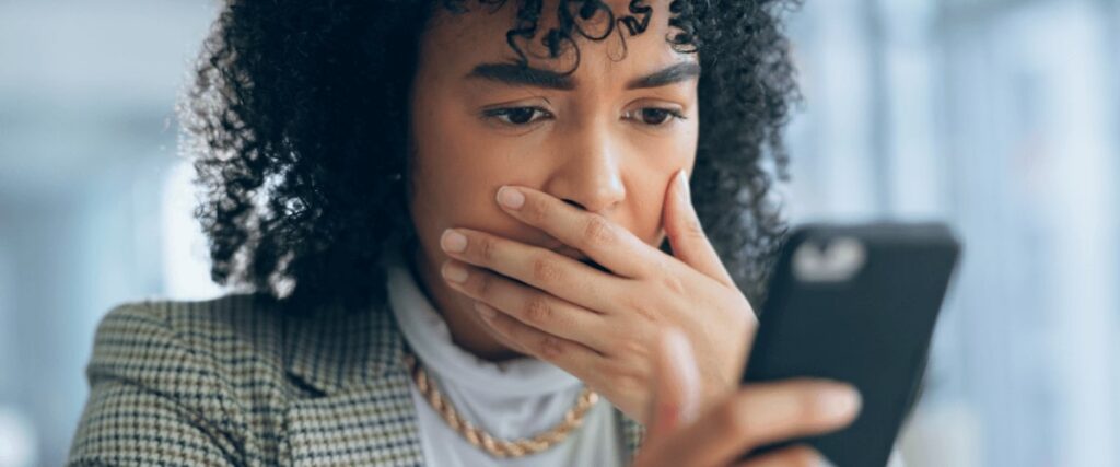 Person worried looking and holding smartphone