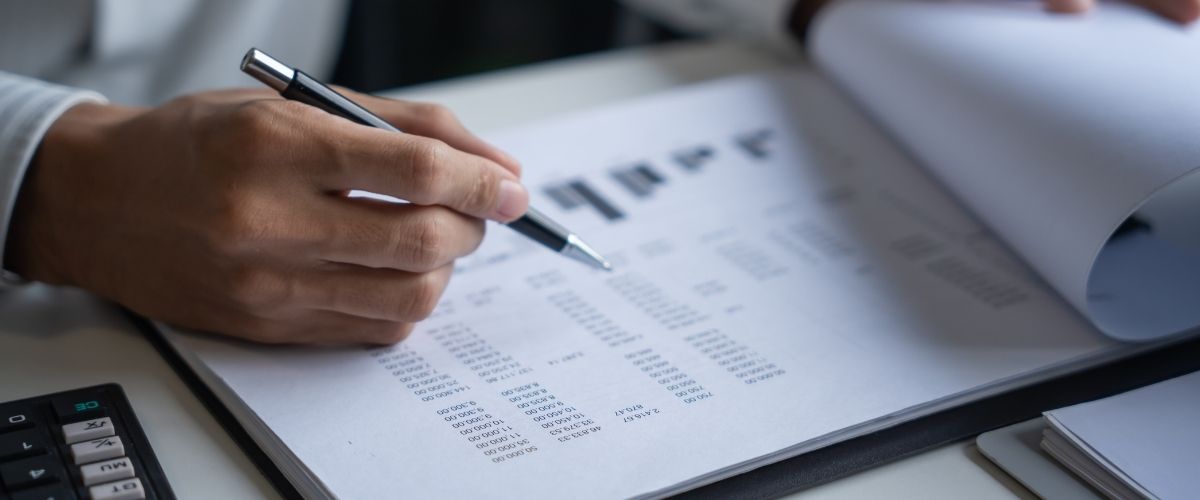 Person writing math on paper