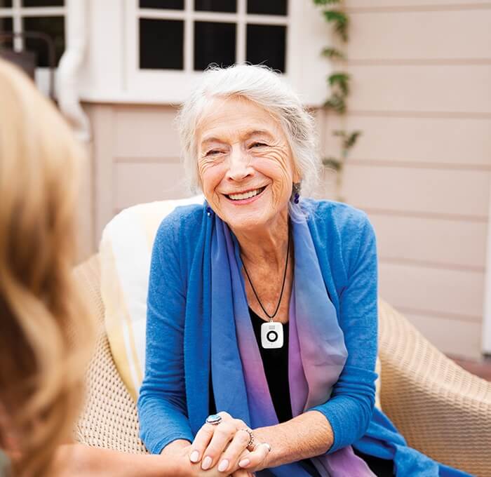 Woman on patio wearing Lifeline Mini