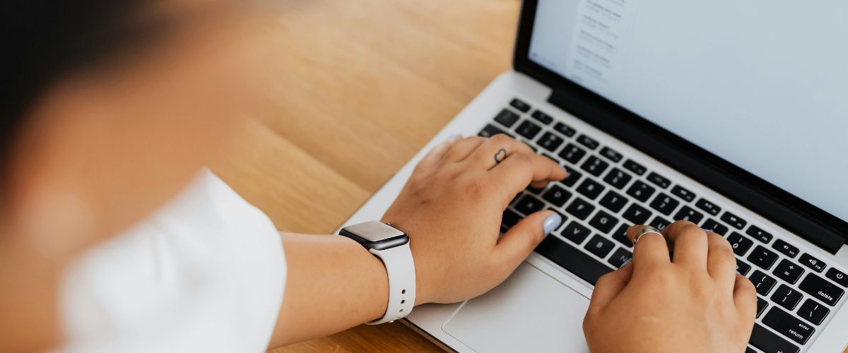 Woman typing on her MacBook