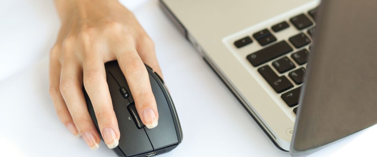 Woman using her laptop mouse